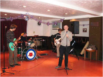 The Fretz who "reformed" for a one-off fun gig at Tamworth Rugby Club at Christmas, 2003. Pictured are (left to right): Andrew Baines (now living in Scotland) on guitar, Donald Ross Skinner (now in London where he is enjoying a successful career in the world of pop) on drums, Matthew Lees (also living in London where he is now a high ranked Government civil servant) and Mark Mortimer (still in Tamworth!) on bass. Photo was taken by Ian "Poge" Harding.